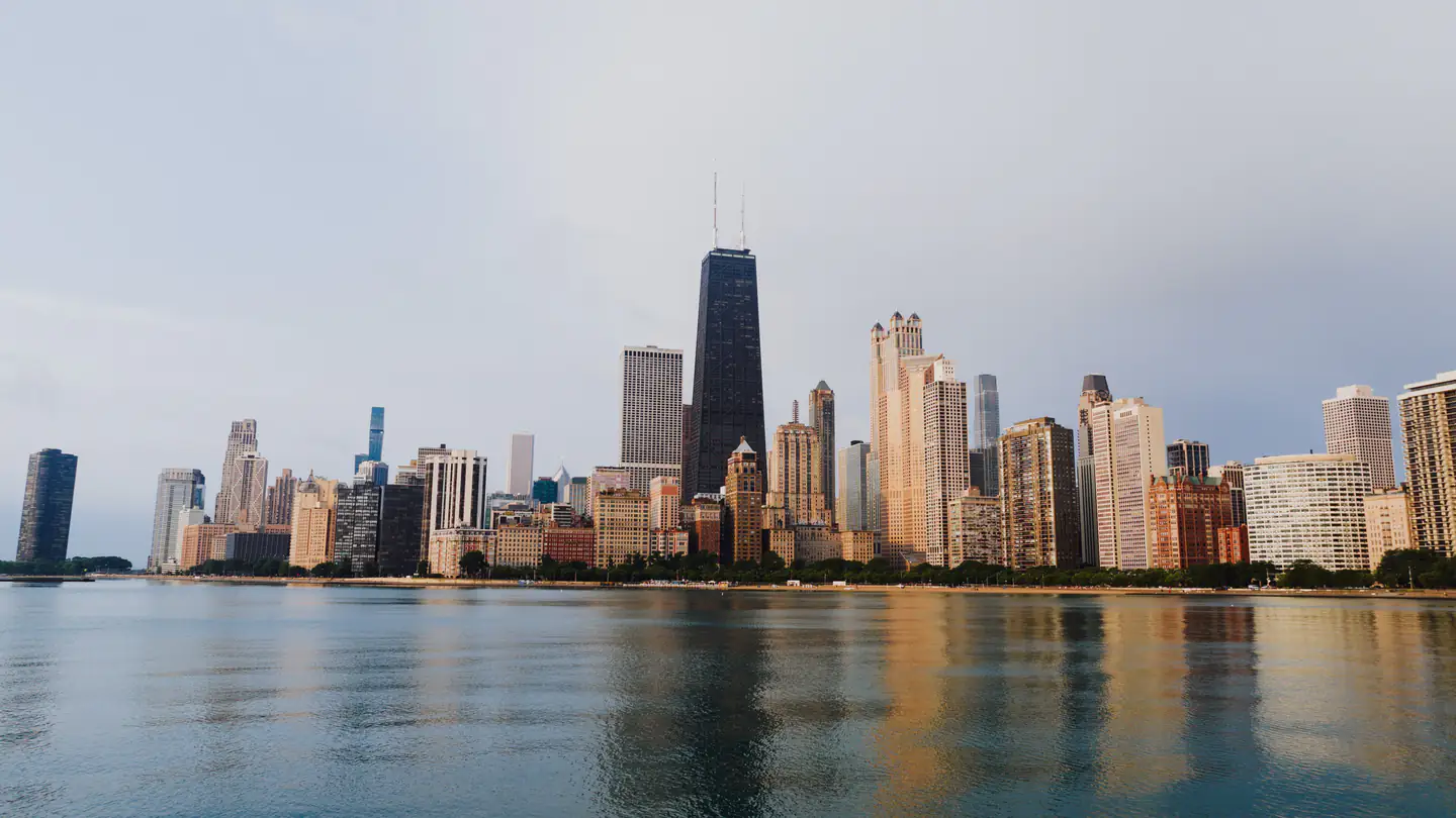 The Chicago skyline seen across open water in late afternoon light.