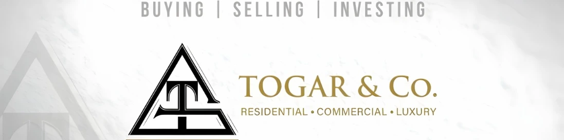 The TOGAR & Co. logo: a triangular T monogram beside the TOGAR & Co. wordmark in antique gold, with the lines Buying | Selling | Investing above and Residential • Commercial • Luxury below